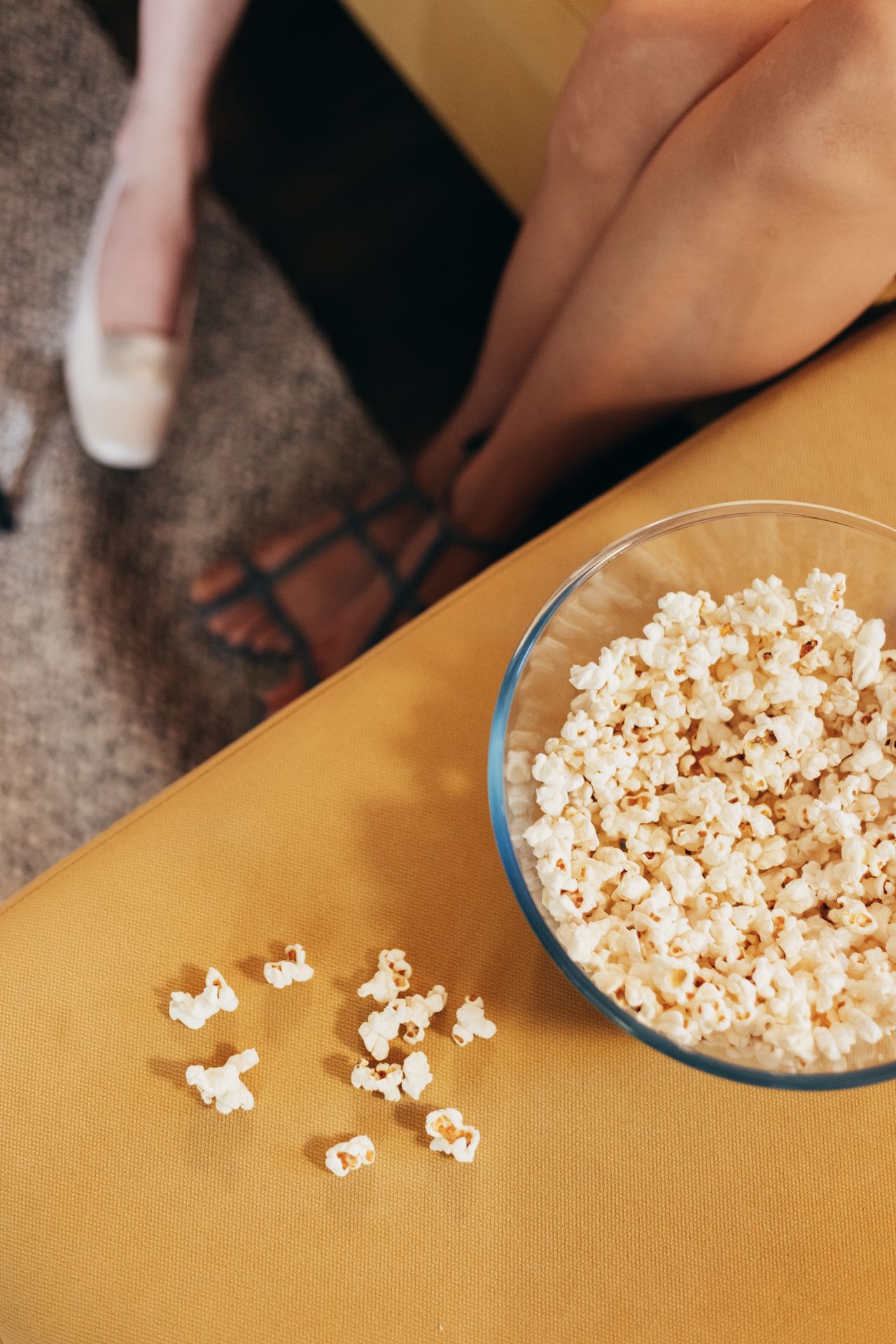 Popcorn and a cozy sofa set up for a Netflix movie night at home